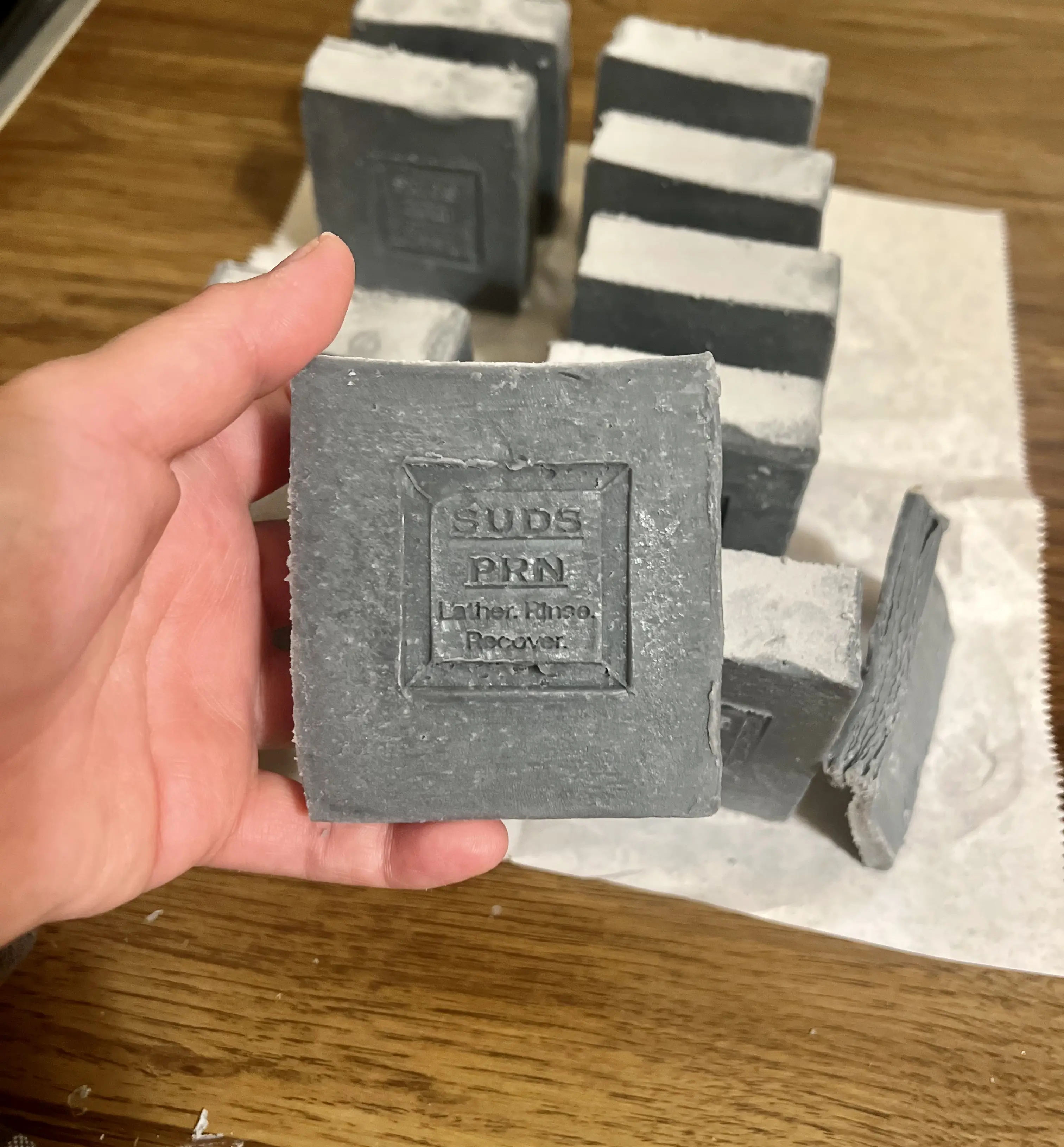 Bombs Away soap bar photographed in hand with the Suds PRN stamp